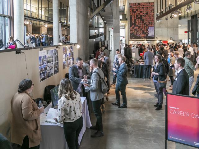 Students and employers participate in Career Day in the center space of Knowlton Hall
