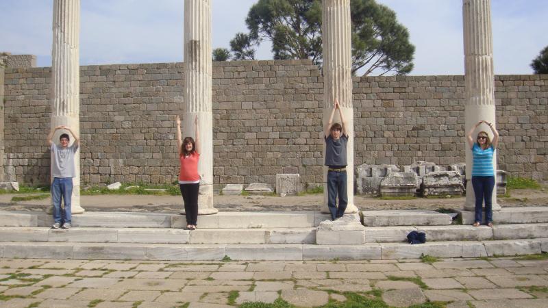 Students standing in front of antique columns