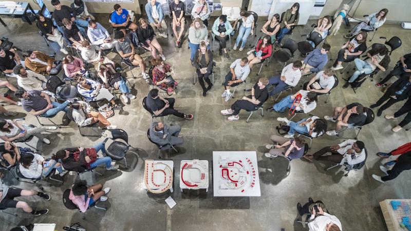Overhead view of senior architecture students and critics during GUI Competition review