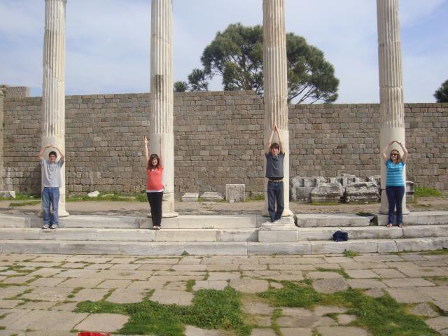 Students standing in front of antique columns