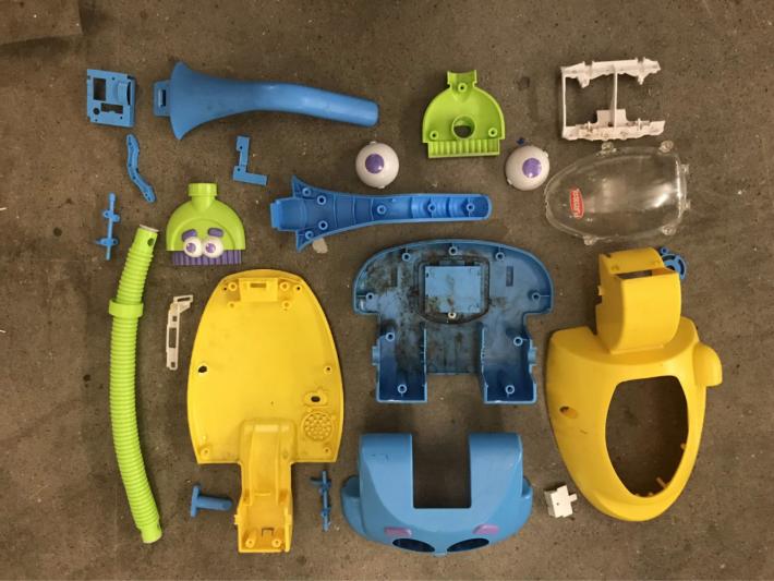 Pieces of a plastic toy that has been disassembled 