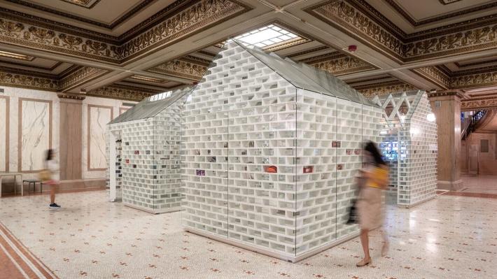 An image of the Gun Violence Memorial Project in Washington, D.C. showing model houses with transparent bricks that display objects from the victims of gun violence across the country.