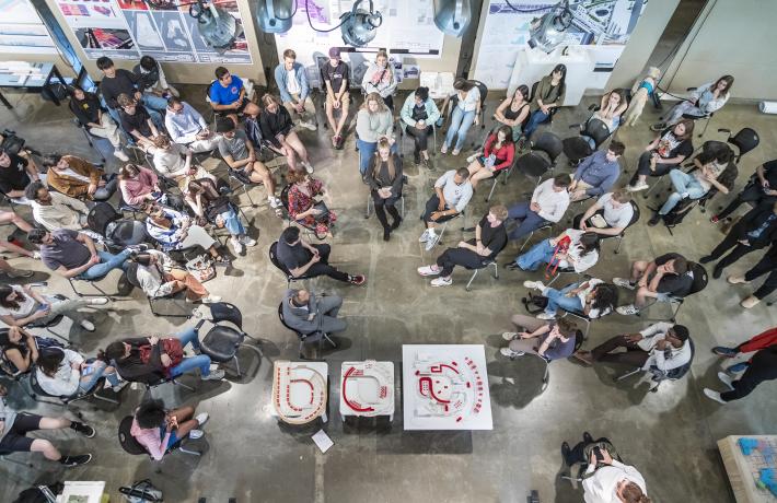 Overhead view of senior architecture students and critics during GUI Competition review