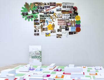 Exhibition showing collage, model, and pamphlet